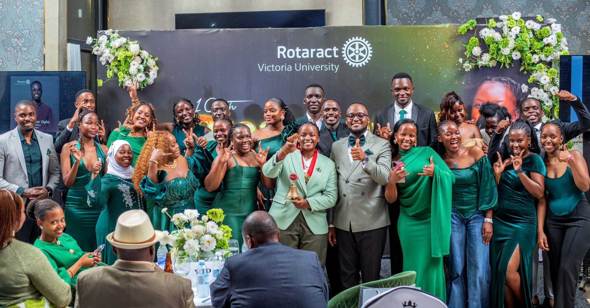 Members of the Rotaract Club of Victoria University celebrating together in green